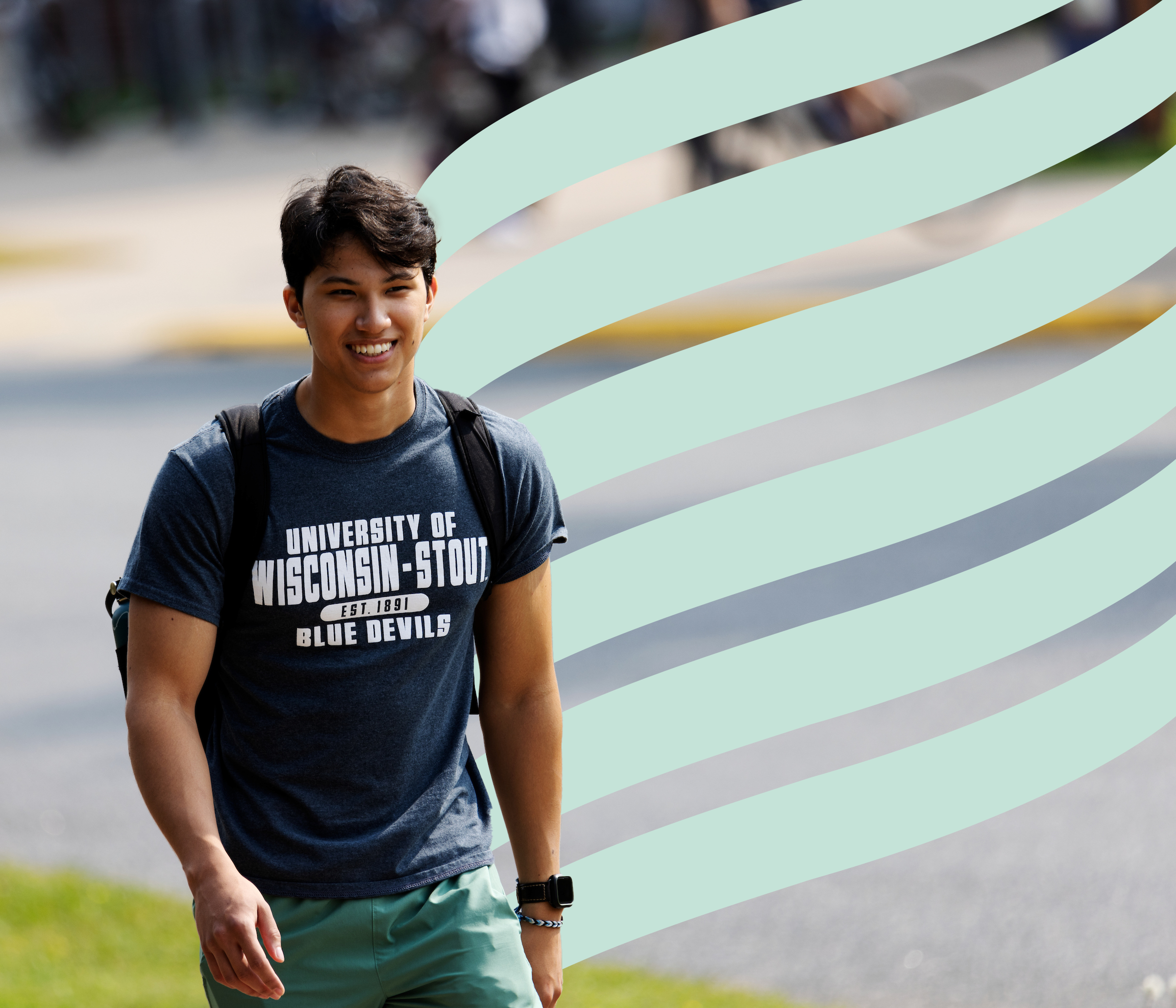 Student smiling while walking outside.