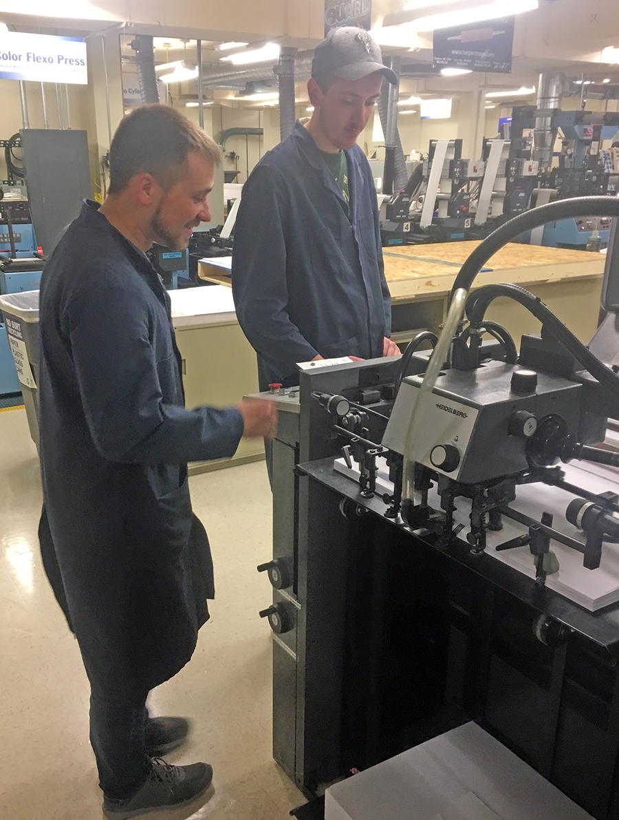 UW-Stout graphic communications seniors Jeff Thones, at left, and Avery Rueckheim complete an offset printing press run for the UW-Stout Journal of Student Research publication. They were part of a team that earned a first-place award for excellence at an annual printing competition sponsored by the Graphic Communications Education Association.