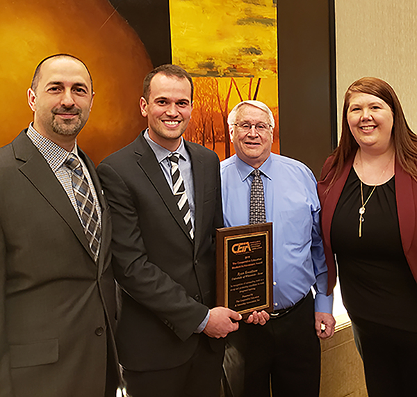 Ryan Knudtson, a Strum native, celebrates his national Cooperative Education Student Achievement award presentation April 2 in Chicago with, from left, Bryan Barts, UW-Stout Career Services director; Doug Church, packaging engineer at Johnsonville, where Knudtson had his co-op; and Bethany Henthorn, UW-Stout co-op program coordinator.