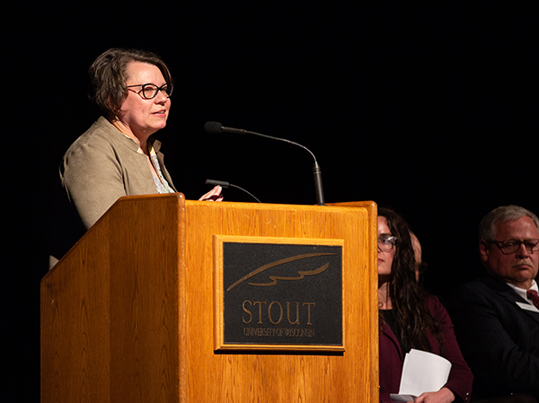 Kim Polzin, president-elect of the Stout University Foundation board, praises Meyer for his work as chancellor.