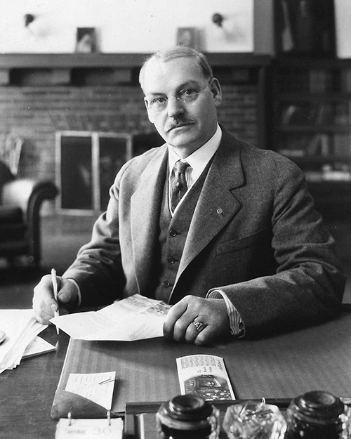 Stout Institute President Burton Nelson sits in his Harvey Hall office in 1936.