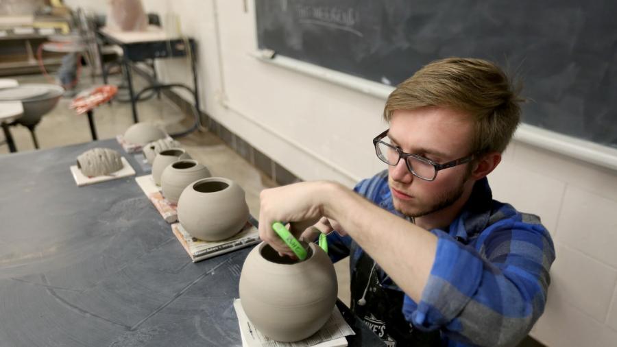 A student works in the ceramics lab in Applied Arts.