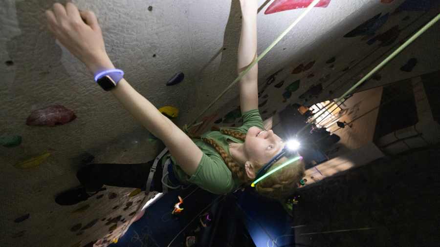 Indoor climbing image of student with headlamp