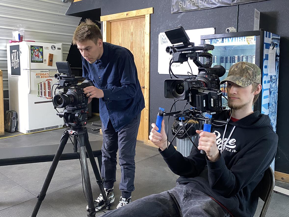 Video production majors Dimitri Luna, left, and Colin Podborny, film during their five-person team’s Project Hope effort
