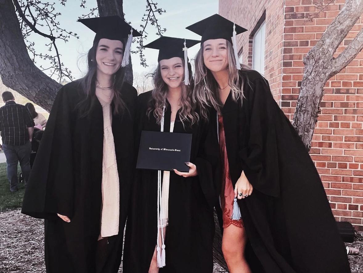 Ariel Kuchta, center, and classmates Elly Soderholm, left, and Megan Edstrom celebrate their graduation May 7 from UW-Stout with interior design degrees.