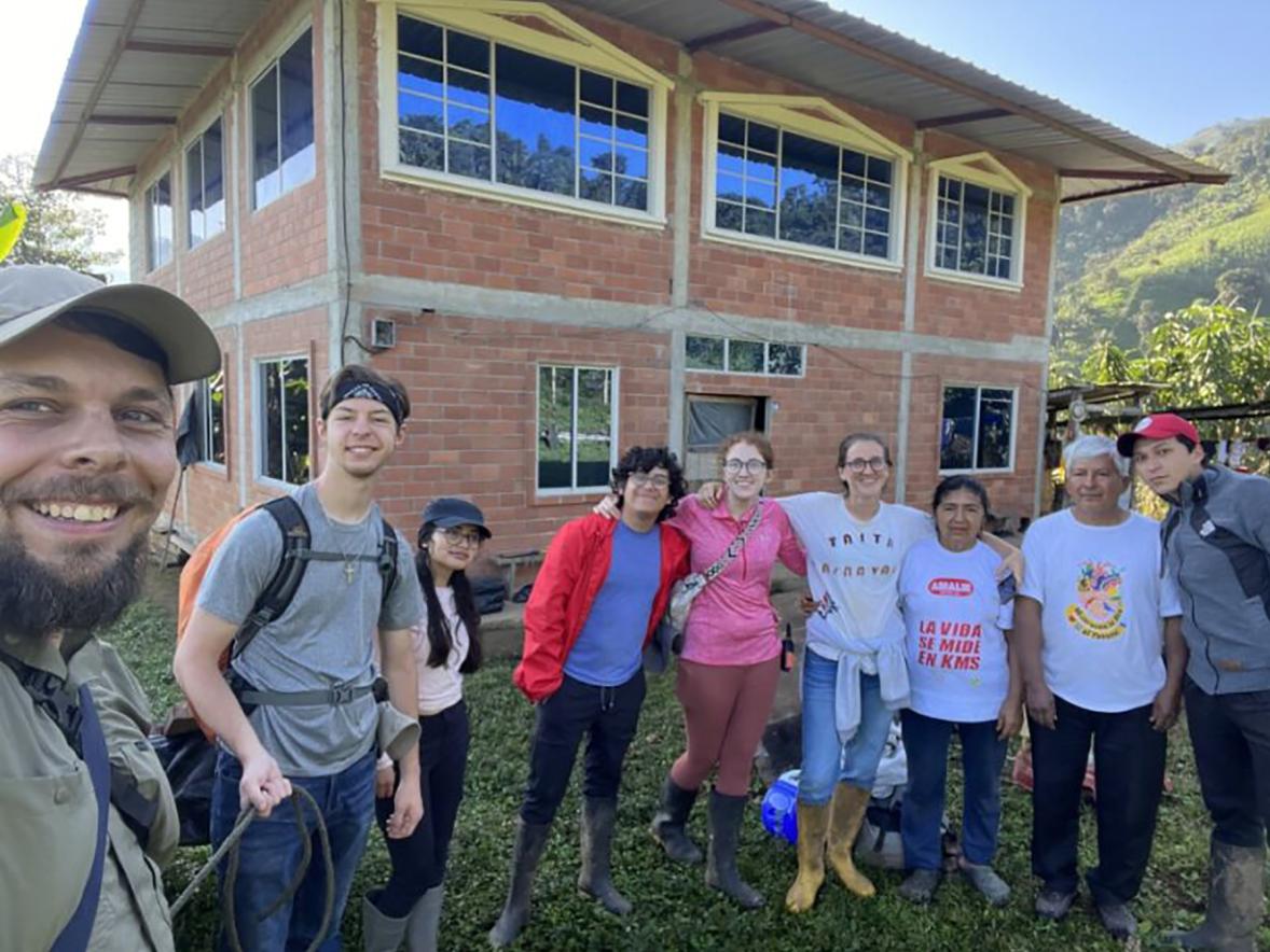 UW-Stout students Jeremiah Hubbard, second from left, Jack Lonn and Elana Showalter, fourth and fifth from left, gather with residents of Naranjal, Ecuador, during their visit last summer to begin work on a village water system.