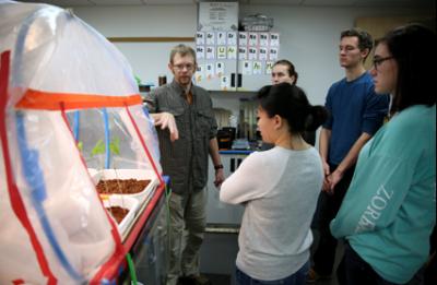 Associate Professor Matt Kuchta, left, talks with students about the Martianlike “Hab,” or habitat, he has created in his lab.