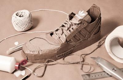 Sneaker prototype made from cardboard and laced with twine.