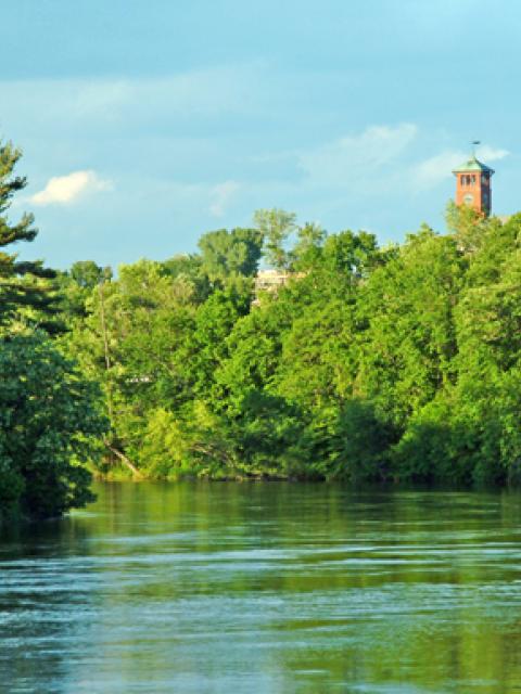 The Red Cedar River flows south out of Menomonie. In the background is UW-Stout’s Bowman Hall Clock Tower.